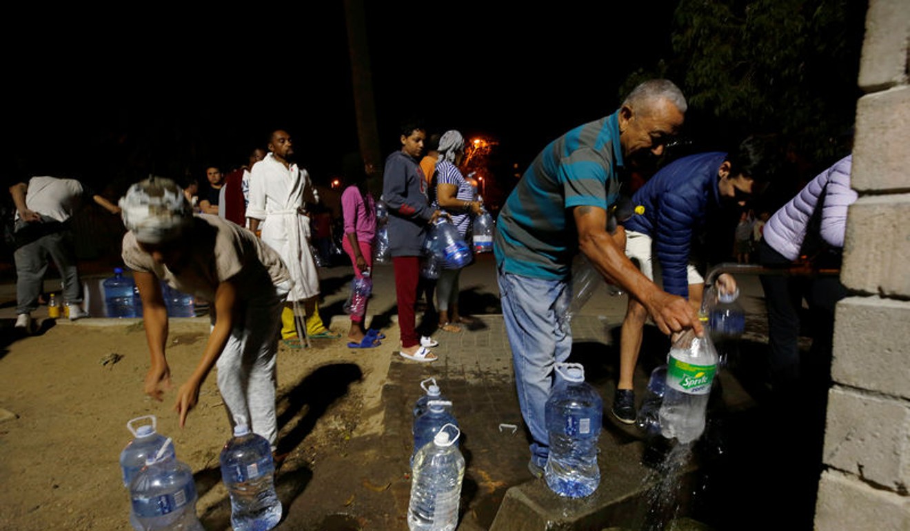 People queue to collect water from a spring in the Newlands suburb, as fears over the city's water crisis grow in Cape Town. Picture taken in January. Photo: Reuters