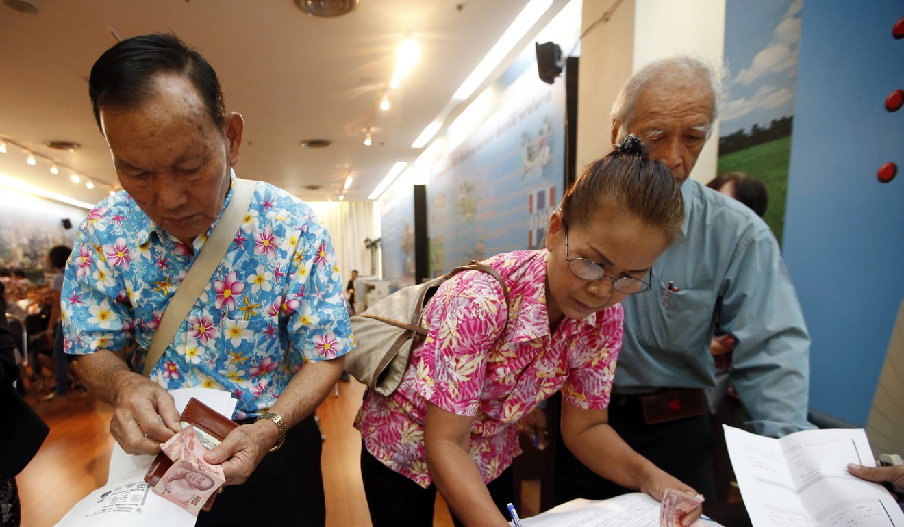 People pay money to register memberships to Pheu Thai Party in Bangkok. Photo: AP