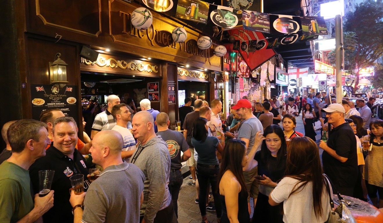 Drinkers congregate on the road outside The Queen Victoria in Wan Chai during Hong Kong Rugby Sevens week. Photo: Dickson Lee