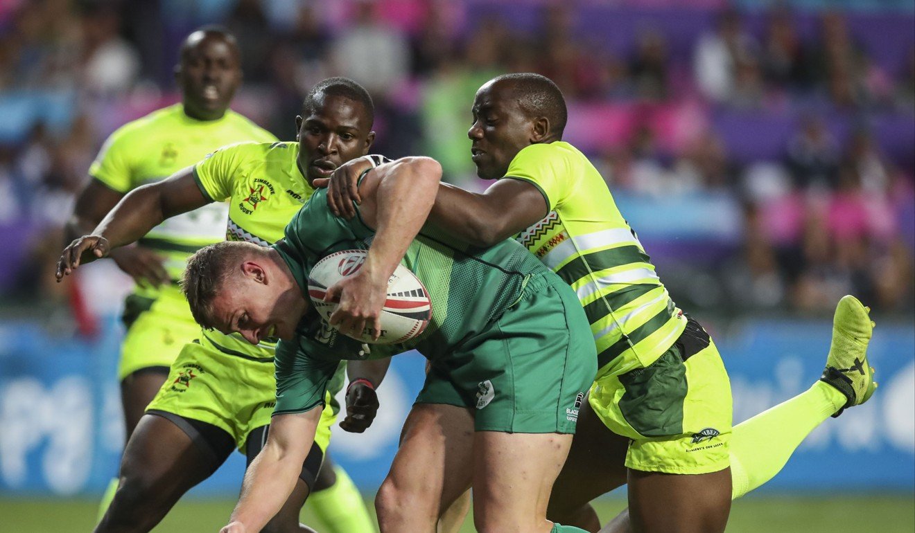 Ireland's John O'Donnell fights his way past Zimbabwe defenders. Photo: Edward Wong