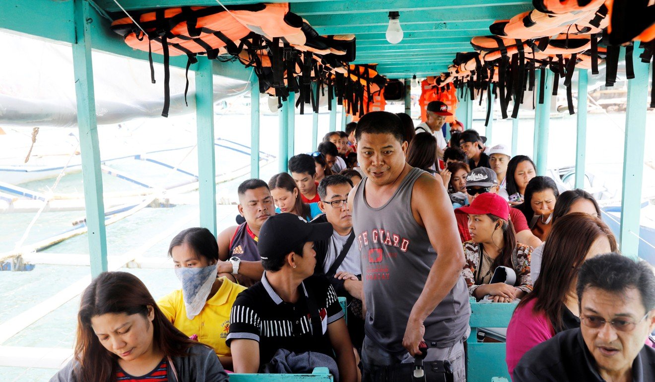 Tourists take a ride on a boat to Boracay from Caticlan jetty port. Photo: Reuters