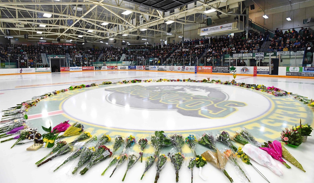 Flowers lie at centre ice as people gather for a vigil at the Elgar Petersen Arena, home of the Humboldt Broncos, to honour the victims of the fatal bus accident. Photo: AFP