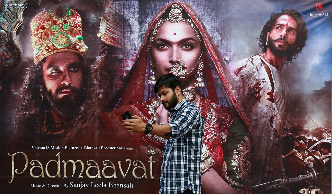 A cinemagoer takes a selfie in front of a poster of Bollywood movie ‘Padmaavat’ outside a movie theatre in Kochi, India, in January. Photo: Reuters