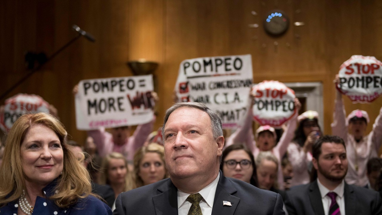Protesters stand and chant with placards as US Secretary of State nominee Mike Pompeo arrives to testify before the Senate Foreign Relations Committee during his conformation hearing on in Washington on Thursday. Photo: AFP