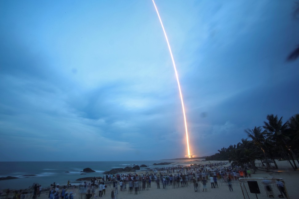 People watch the launch of the Long March 5 rocket from a beach in Hainan. After the failure of the July 2017 mission, an improved version of the rocket is set to lift off before the end of this year. Photo: Reuters