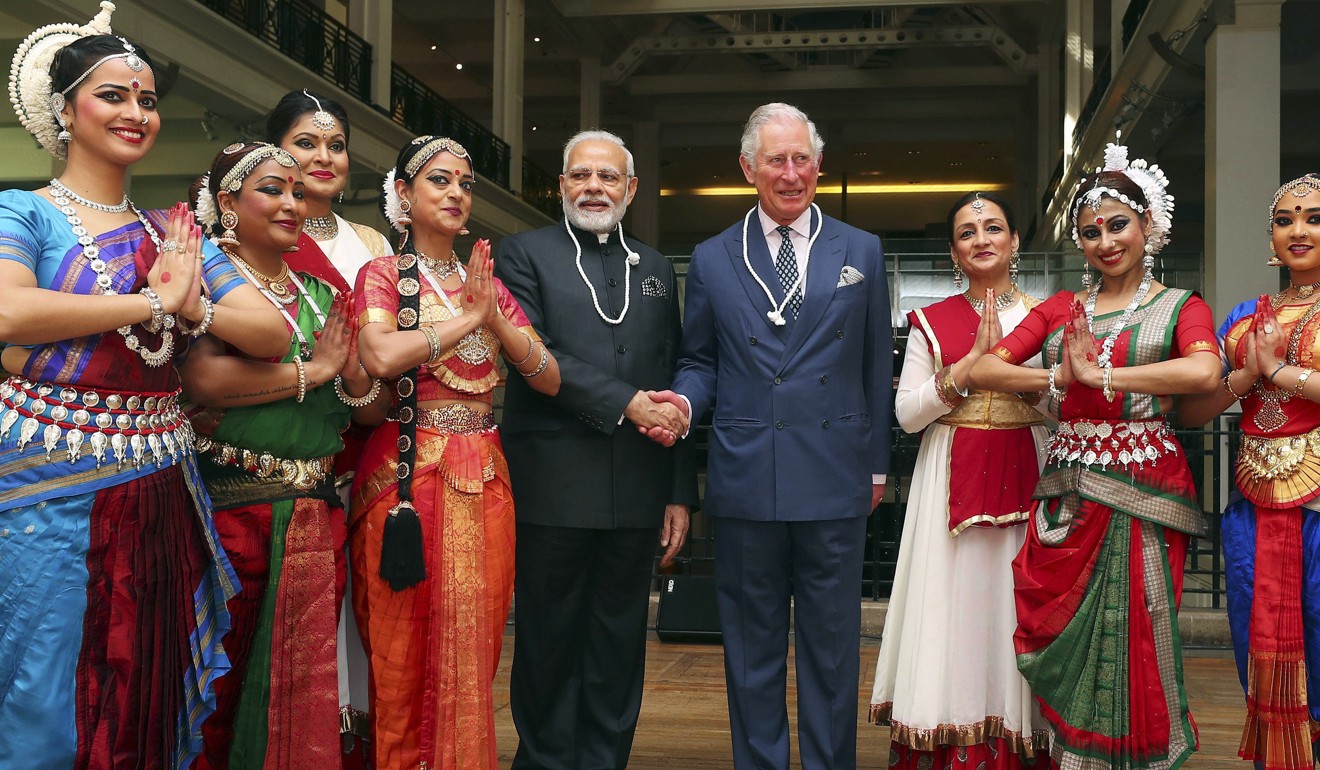 India's Prime Minister Narendra Modi and Britain's Prince Charles pose with dancers during a visit to the Science Museum in London on Wednesday. Photo: AP
