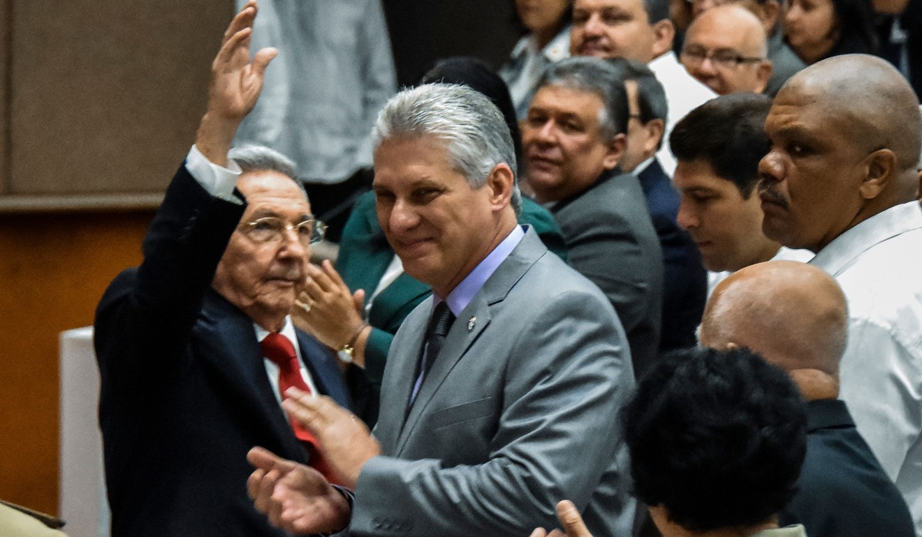 Cuban President Raul Castro waves next to First Vice-President Miguel Diaz-Canel, center, during a national assembly session that will select Cuba's council of state ahead of the naming of a new president, in Havana on Wednesday. Photo: AFP