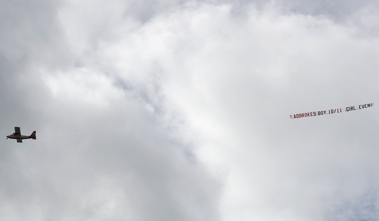 A light aircraft towing the royal baby odds from a bookmaker flies over St Mary's Hospital in central London on April 9. Photo: AFP