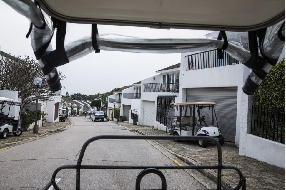Golf carts sit in front of houses. Photo: Justin Chin/Bloomberg