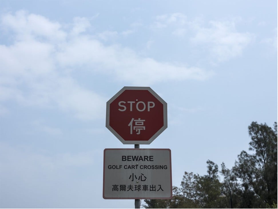 A caution sign warns against golf carts. Photo: Justin Chin/Bloomberg