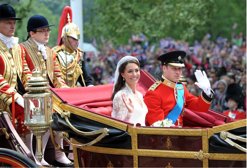 Britain's Prince William and his wife Kate, Duchess of Cambridge, wave as they travel in the 1902 State Landau carriage along the Processional Route to Buckingham Palace after their wedding service in London in 2011. Photo: AFP
