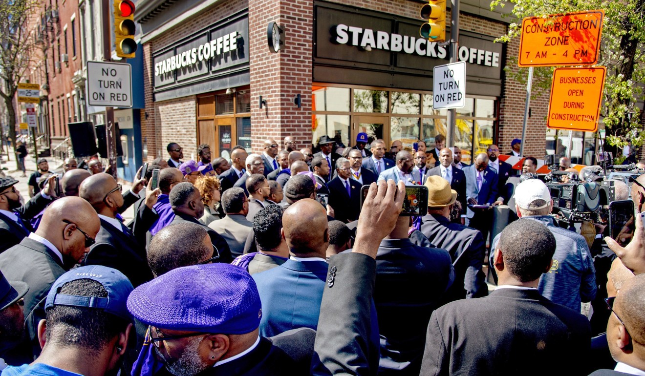Omega Psi Phi Fraternity members rally on April 22 outside the Starbucks where one of their fraternity brothers was one of the two black men arrested on April 12 for trespassing, in Philadelphia. Photo: AP  