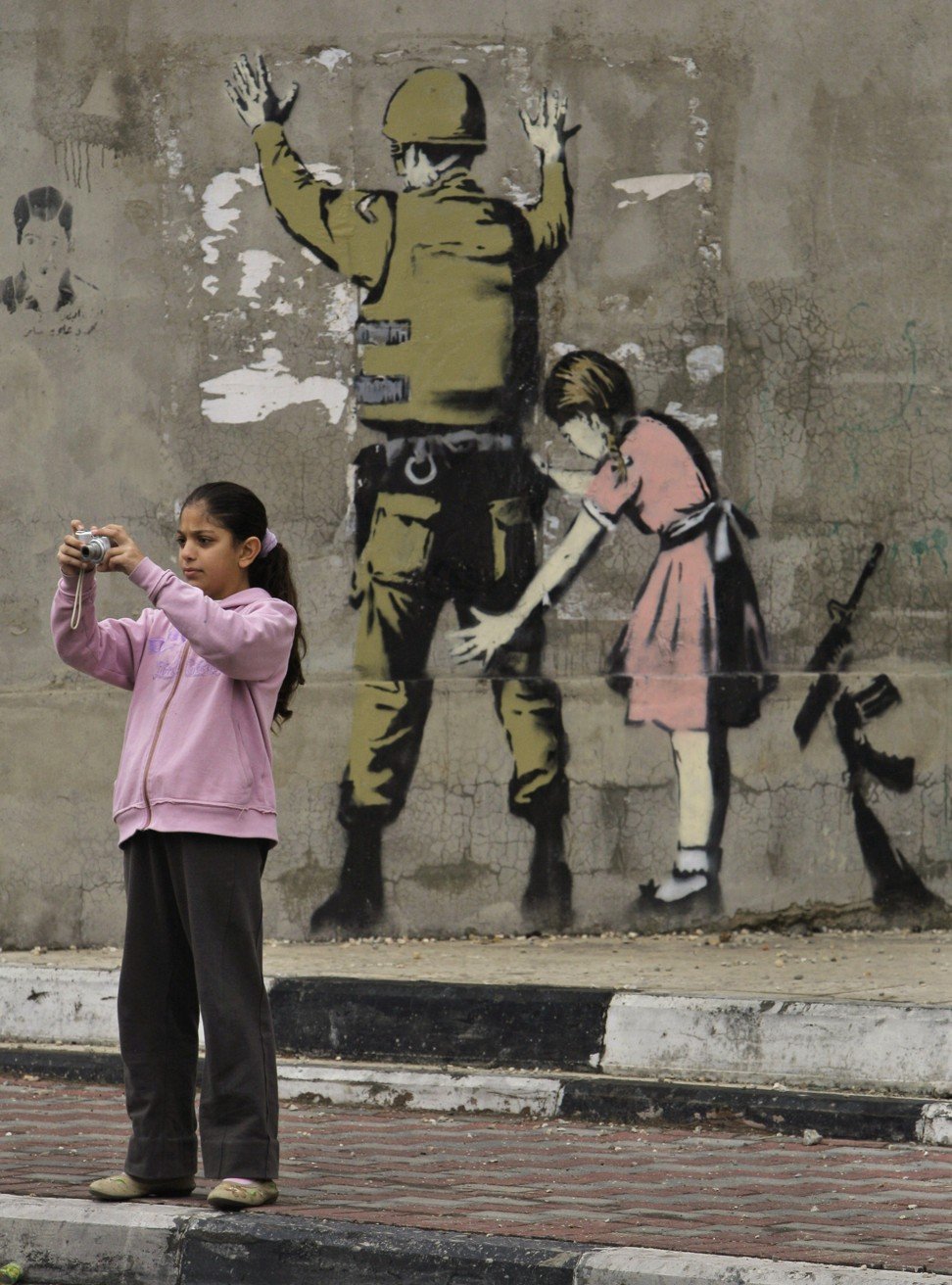 A work by British graffiti artist Banksy on a wall in the West Bank town of Bethlehem. Photo: AP