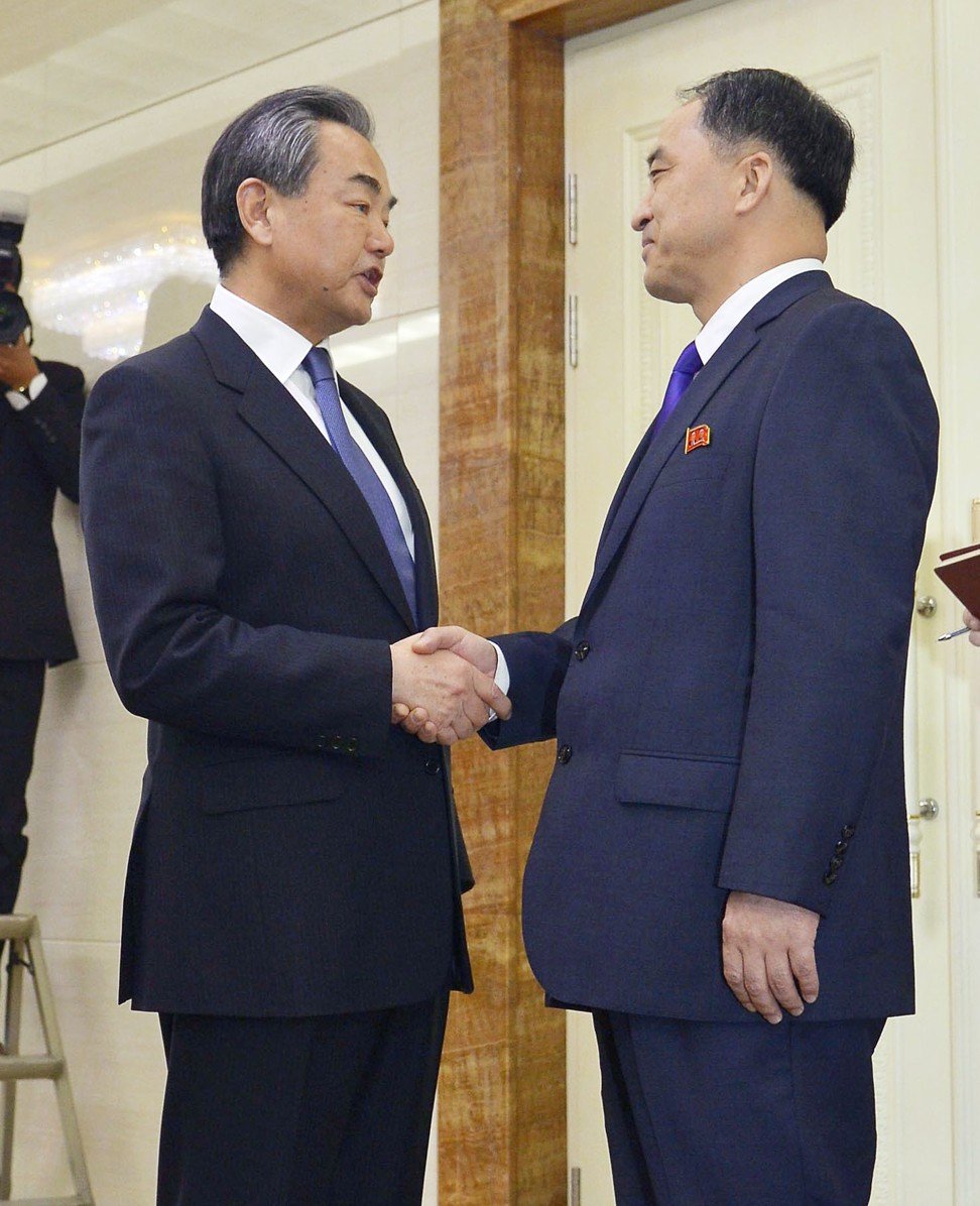 Chinese Foreign Minister Wang Yi (left) is greeted by the North’s Deputy Foreign Minister Ri Kil-song at Pyongyang airport. Photo: Kyodo