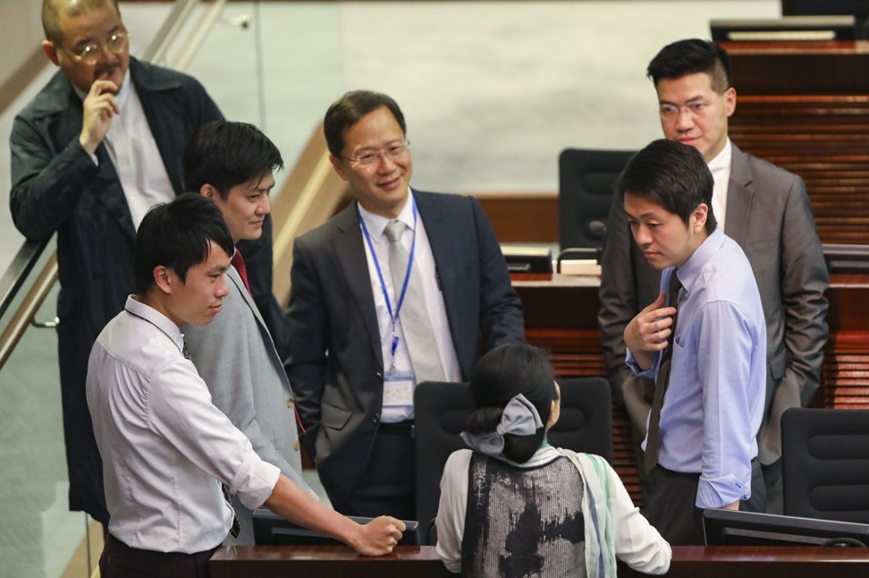 Lawmakers gather around Hui (right, front) at the Legislative Council House Committee. Photo: Edward Wong