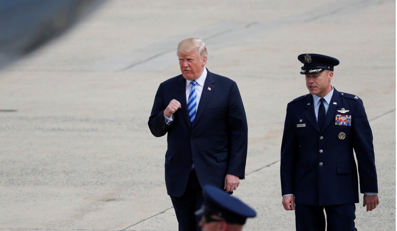 US President Donald Trump makes a fist while walking across the tarmac to Air Force One as he heads to the National Rifle Association convention in Dallas on May 4, 2018. Photo: Reuters