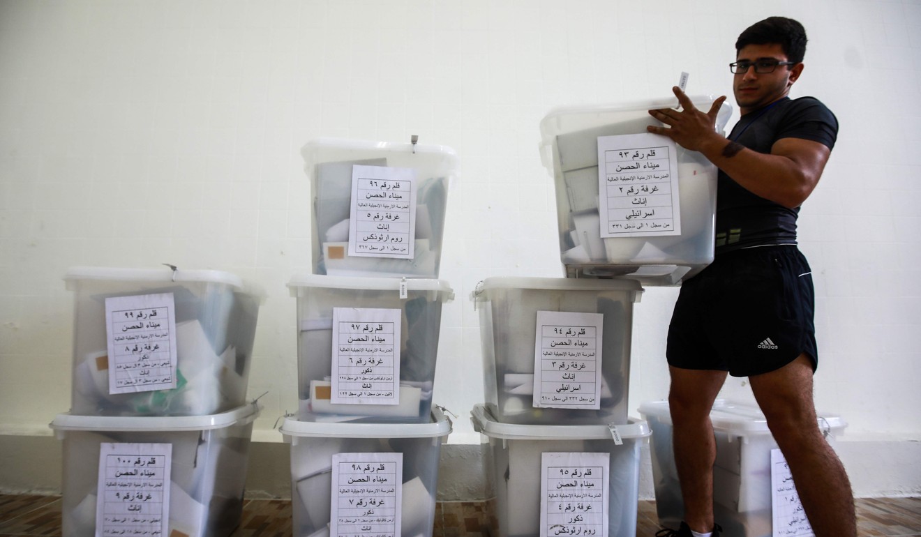 A Lebanese government employee sorts sealed electoral ballot boxes. Photo: AFP