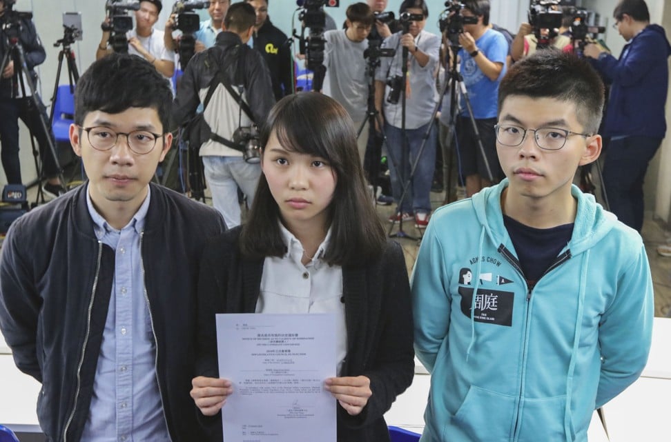 Law (left), Chow and Wong after Chow’s candidacy was ruled invalid by returning officer Teng. Photo: Felix Wong