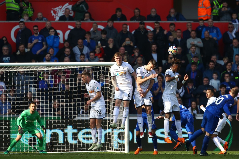 Rooney lifts a free kick over the Swansea wall and over the bar. Photo: AFP