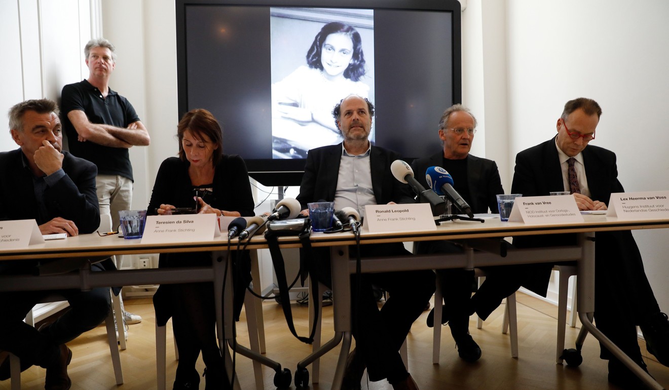 Researchers speak in front of a screen displaying a picture of Anne Frank as the Anne Frank House publishes unknown text of the young Jew who hid from the Nazis with her family in the Dutch capital, on May 15, 2018 in Amsterdam. Photo: Agence France-Presse