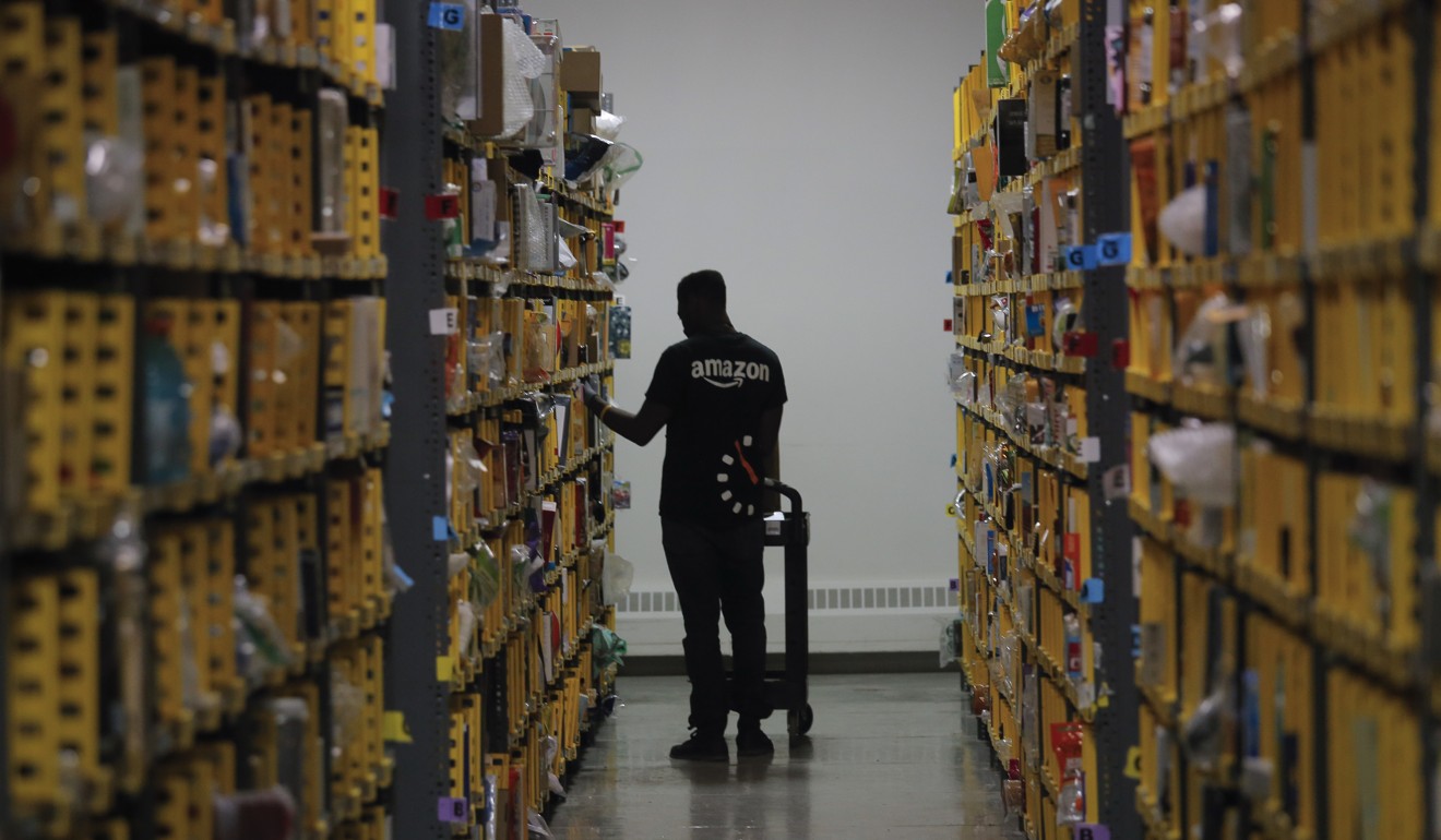 An Amazon employee stacks shelves at a distribution hub in New York to cope with customers’ last-minute holiday orders in December 2016. Online shopping offers consumer convenience and the possibility of lower prices. Photo: AP
