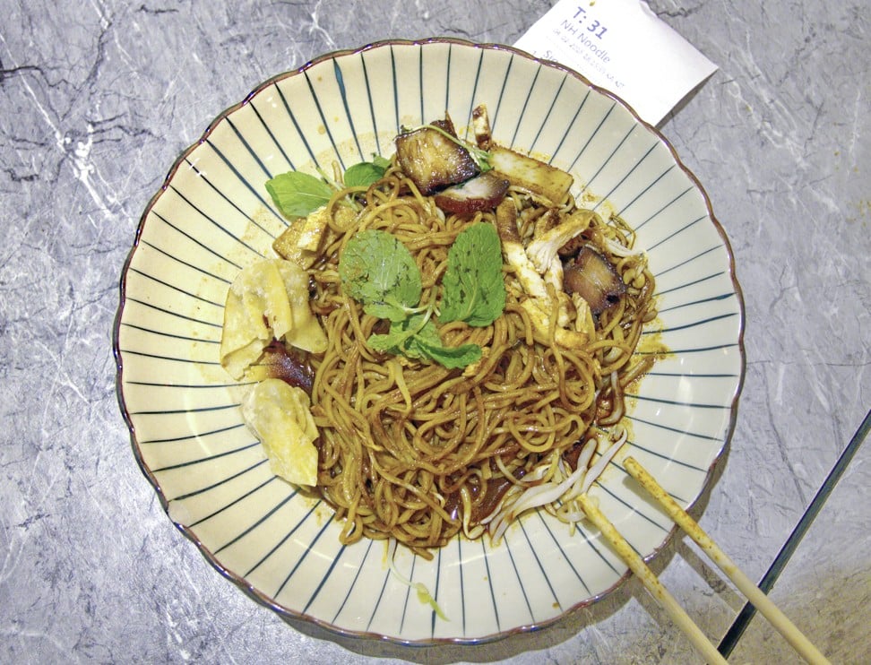 Dry curry mee served by a robot at Nam Heong. Picture: Keith Mundy