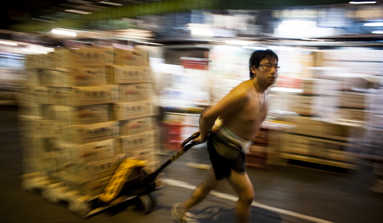 Each night shirtless men can be seen hauling boxes of fruit between market stalls and refrigerated trucks. Photo: Christopher DeWolf