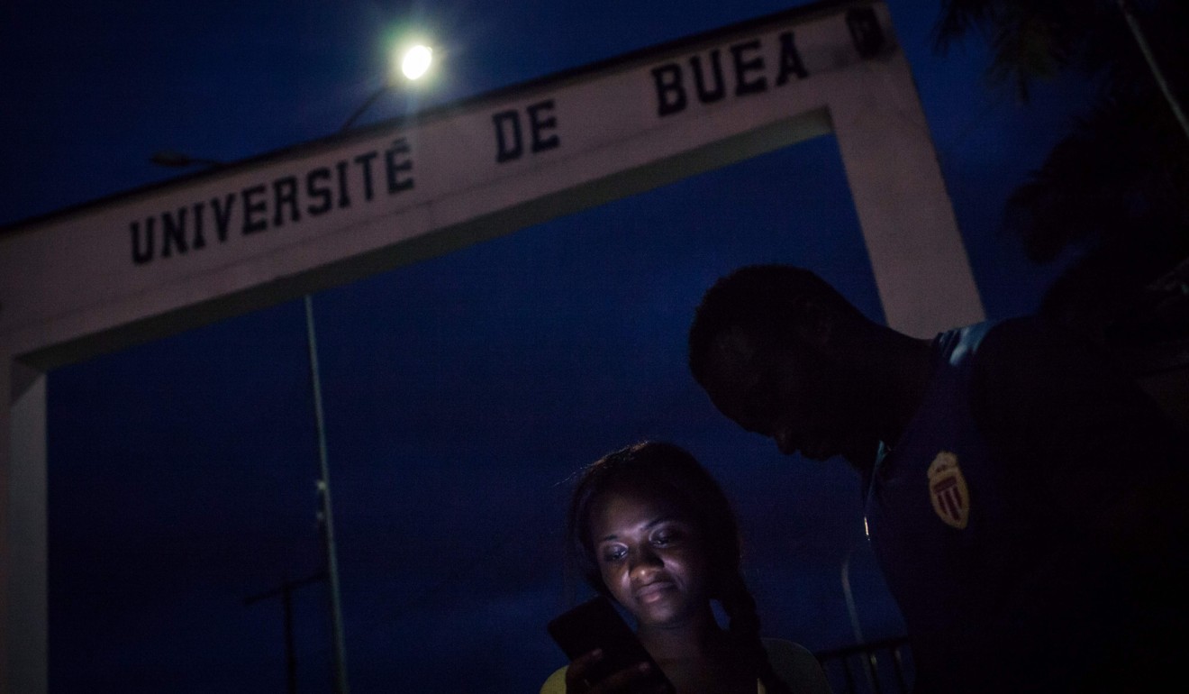 University of Buea students chat by the entrance of the English-language university in the Southwest Region of Cameroon. Photo: Agence France-Presse