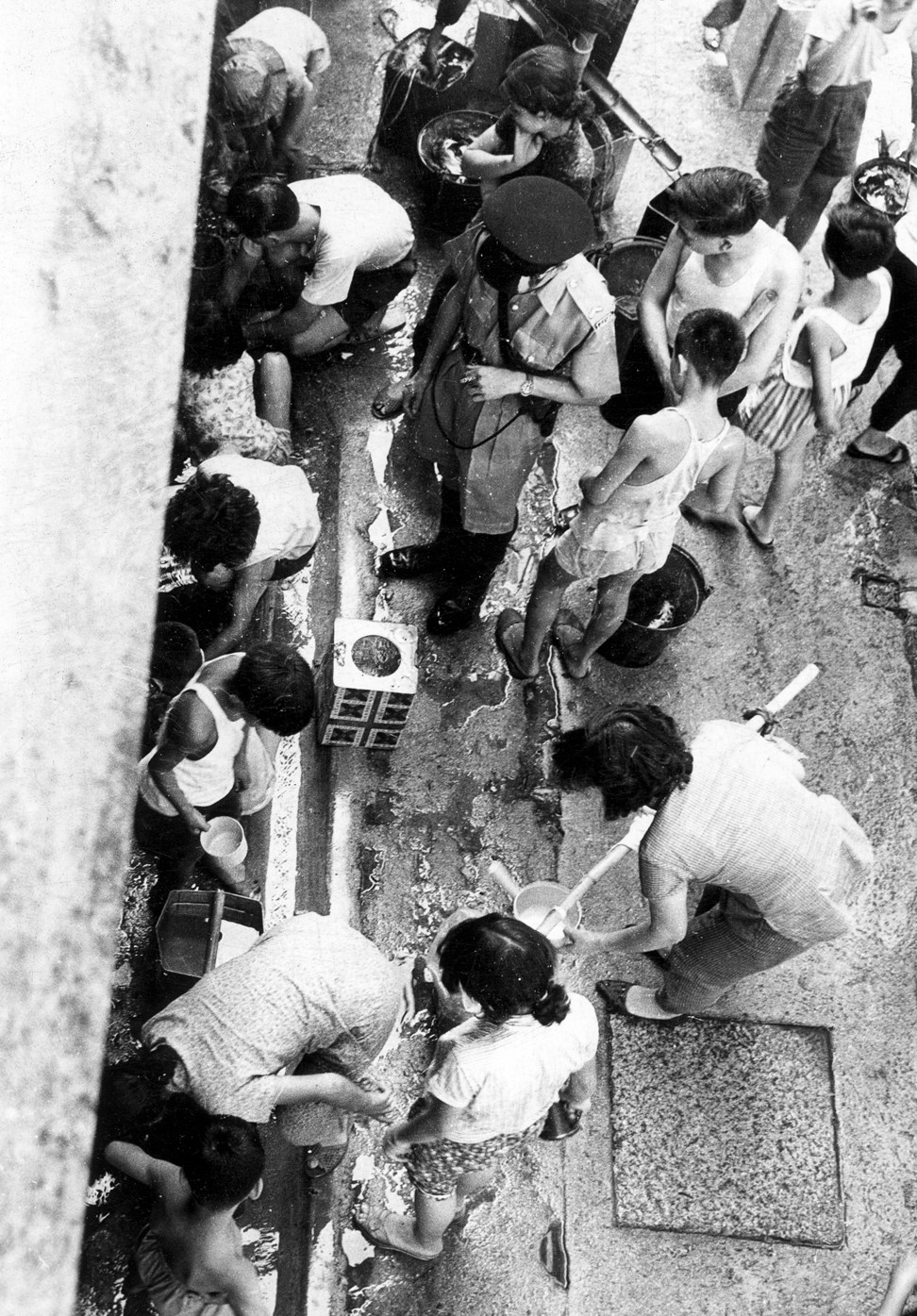 Residents collect water at Po Hing Fong in Sheung Wan, during a drought in June 1963. Photo: SCMP