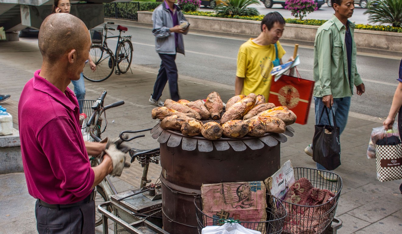 A vendor of roasted sweet potatoes in Beijing. Picture: Alamy