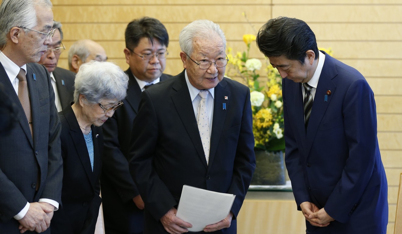 Japanese Prime Minister Shinzo Abe (right) greets Shigeo Iizuka (centre), leader of a group of families of Japanese people abducted by North Korea, and Sakie Yokota (second from left), the mother of one of the abductees, in Tokyo on March 30. North Korea has admitted to abducting 13 Japanese citizens between 1977 and 1983 as part of an espionage programme, but hundreds more may have been taken and Abe has pledged to resolve the issue. Photo: EPA-EFE