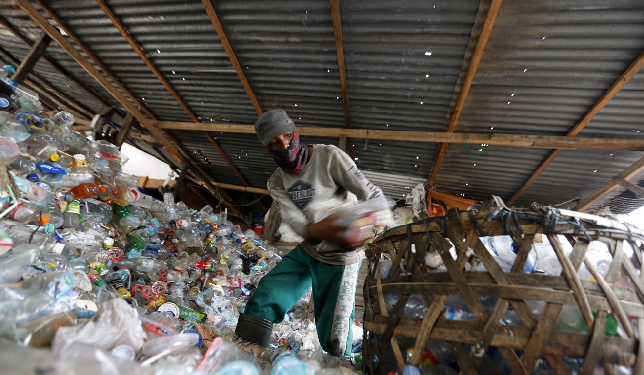 A worker sorts scrap plastic to be recycled at a recycling plant in Banda Aceh, Indonesia. World Environment Day is celebrated around the globe on 5 June, this year the theme is beat plastic pollution. Photo: EPA