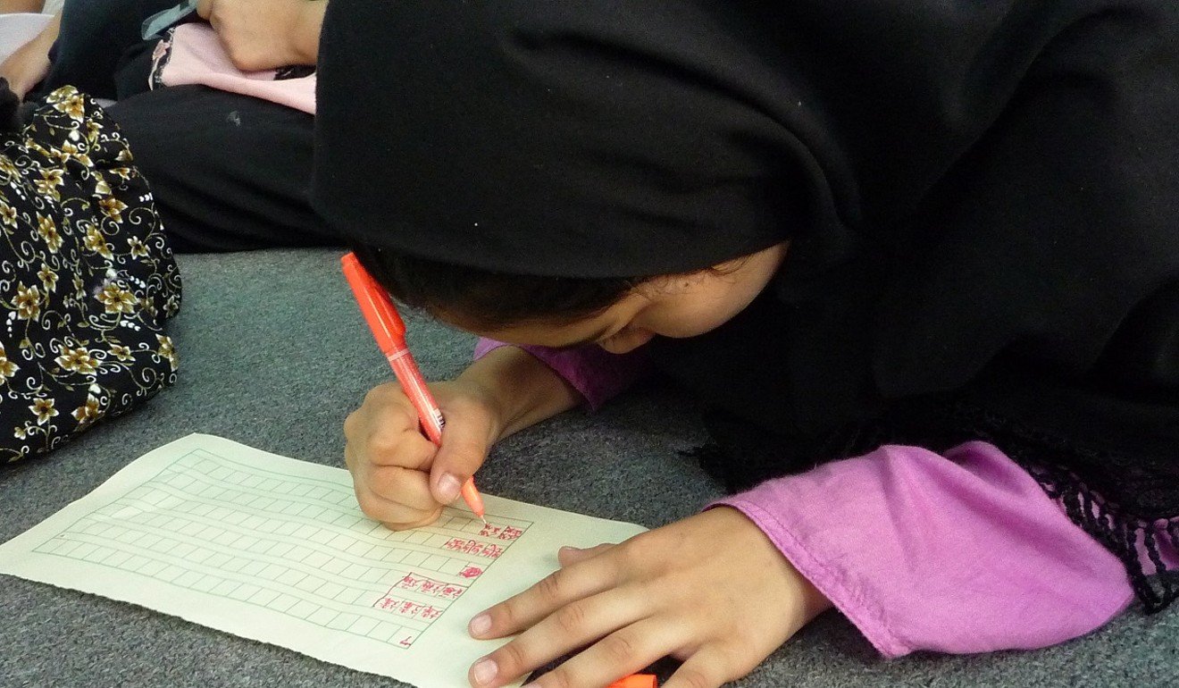 A child practises writing Chinese at an activity organised by the Zubin Foundation. The Education Bureau has encouraged ethnic minority parents to immerse their children in a Chinese-speaking environment, but this can prove challenging. Photo: Zubin Foundation