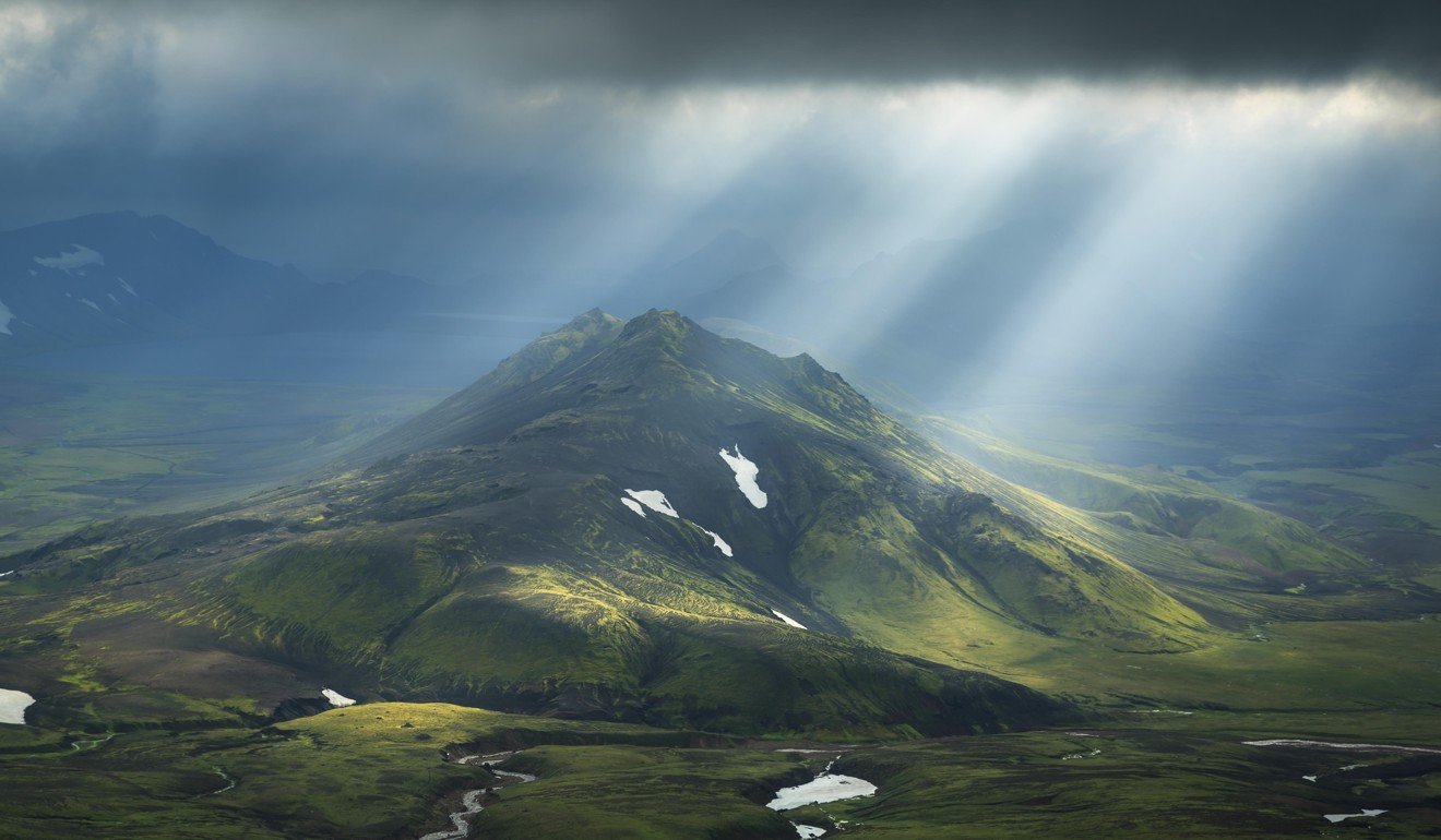 Sun breaks through the clouds on a mountain on the Laugavegur hiking trail in Iceland. Picture: Alamy