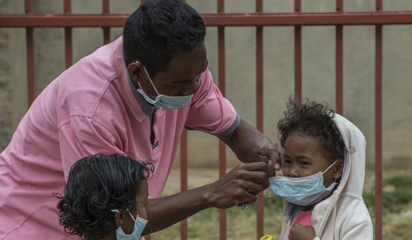 Children are helped with face masks in Antananarivo, Madagascar, in October 2017, when the country struggled with an outbreak of plague. Madagascar’s 25 million people share a GDP per capita of barely US$400. Photo: AP