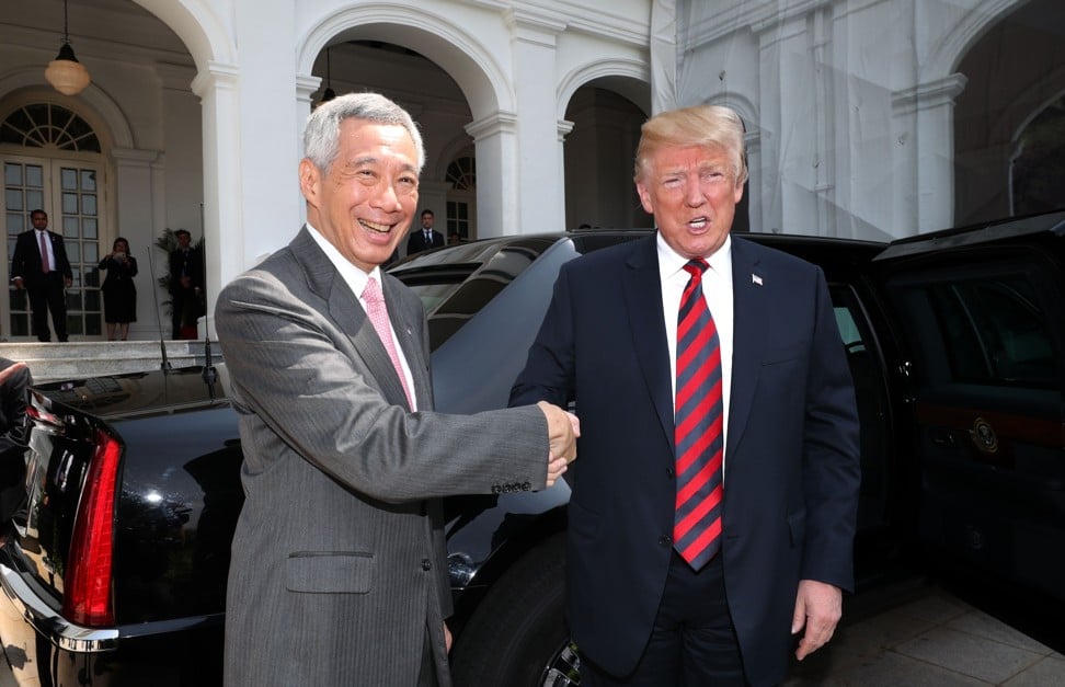 US President Donald Trump (right) shakes hands with Singapore’s Prime Minister Lee Hsien Loong on Sunday. Trump’s historic meeting with North Korean leader Kin Jong-un is on the same day the United States’ new de facto embassy in Taiwan is unveiled. Photo: AFP
