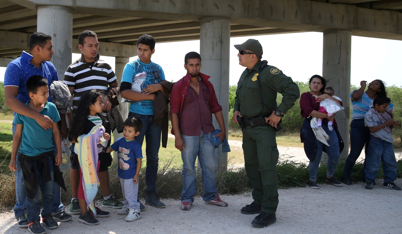 Border patrol agent Sergio Ramirez talks with immigrants who illegally crossed the border from Mexico into the US in the Rio Grande Valley sector, near McAllen, Texas, on April 2. Photo: Reuters