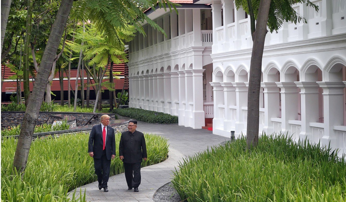 US President Donald Trump (left) and North Korean leader Kim Jong-un chat during a walk through the grounds of the Capella Hotel in Singapore on Tuesday. Photo: EPA-EFE