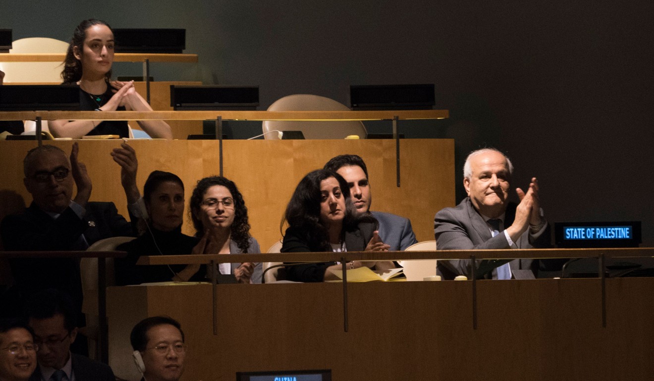 Palestinian Ambassador to the United Nations Riyad Mansour applauds the results of the vote to condemn Israeli actions in Gaza, in the General Assembly on June 13 in New York. Photo: Agence France-Presse