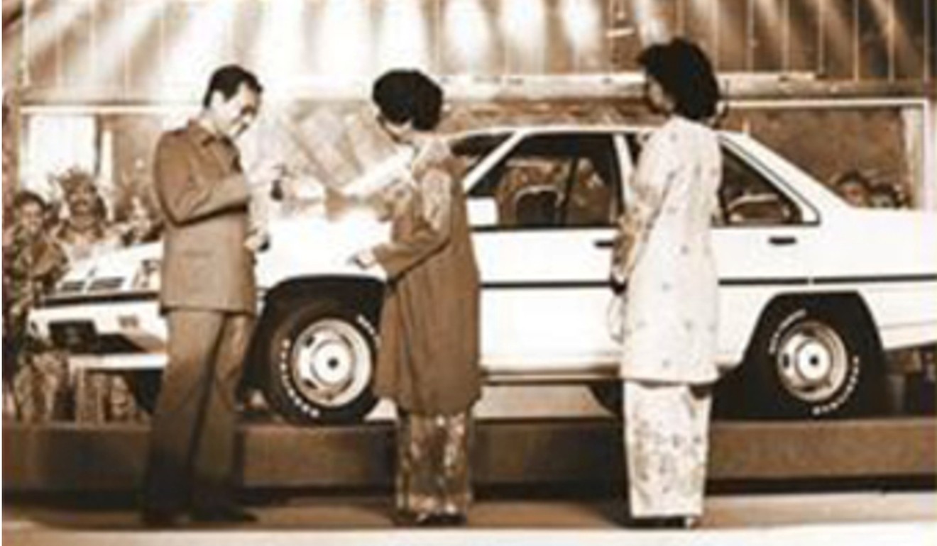 Malaysian Prime Minister Mahathir Mohamad with an early Proton car. File photo