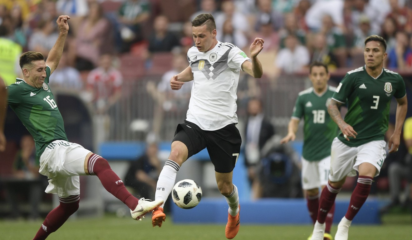 Germany's forward Julian Draxler vies for the ball with Mexico's midfielder Hector Herrera. Photo: AFP