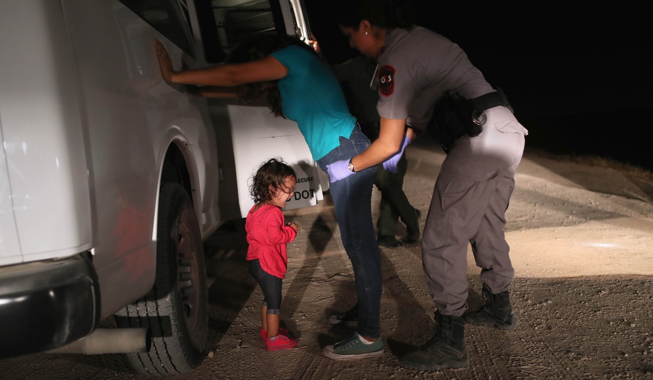 A two-year-old Honduran asylum seeker cries as her mother is searched and detained near the U.S.-Mexico border on June 12 in McAllen, Texas. Photo: Getty Images via AFP