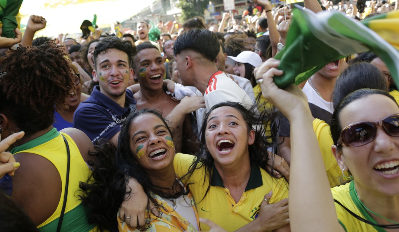 Brazilian soccer fans celebrate their team's first goal as they watch a live telecast in Rio de Janeiro. Photo: AP