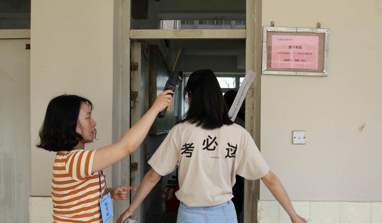A student is checked with a metal detector before she enters a classroom for the ‘gaokao’, in Yangzhou, Jiangsu province, China on June 7, 2018. The Chinese characters on the T-shirt read, ‘Pass for sure’. Photo: Reuters