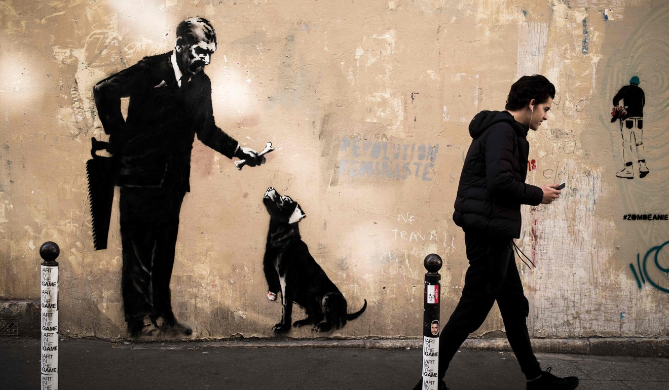 A man walks past a recent artwork by street artist Banksy in Paris on June 24, 2018. Photo: AFP/Banksy