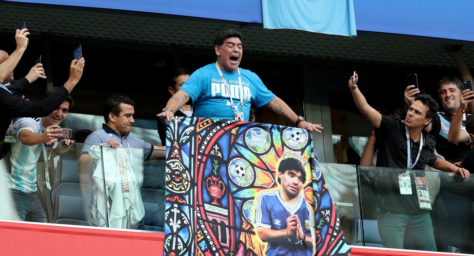 Maradona interacts with fans before the match. Photo: EPA