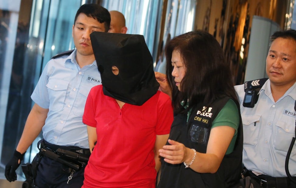 Suspect, centre, arrested for a shooting case in Quarry Bay Park, photographed in Tai Koo. Photo: Dickson Lee/ Dickson Lee