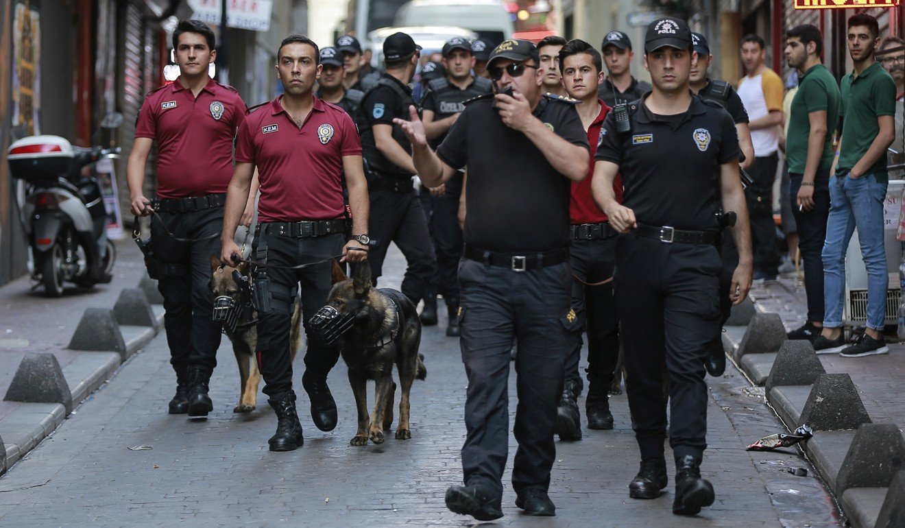 A phalanx of police officers follow protesters on Sunday. Photo: AP
