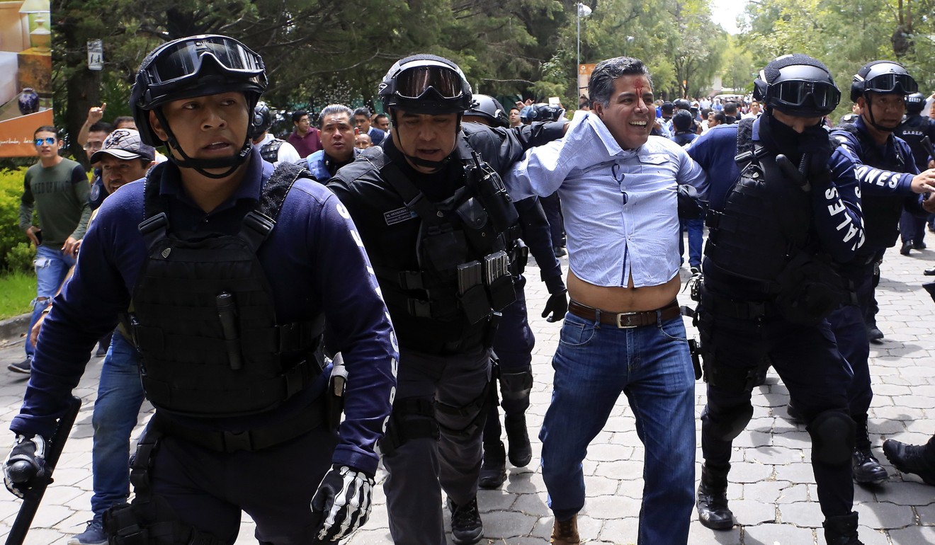 A man is arrested after supporters of presidential candidate Andres Manuel Lopez Obrador. Photo: EPA