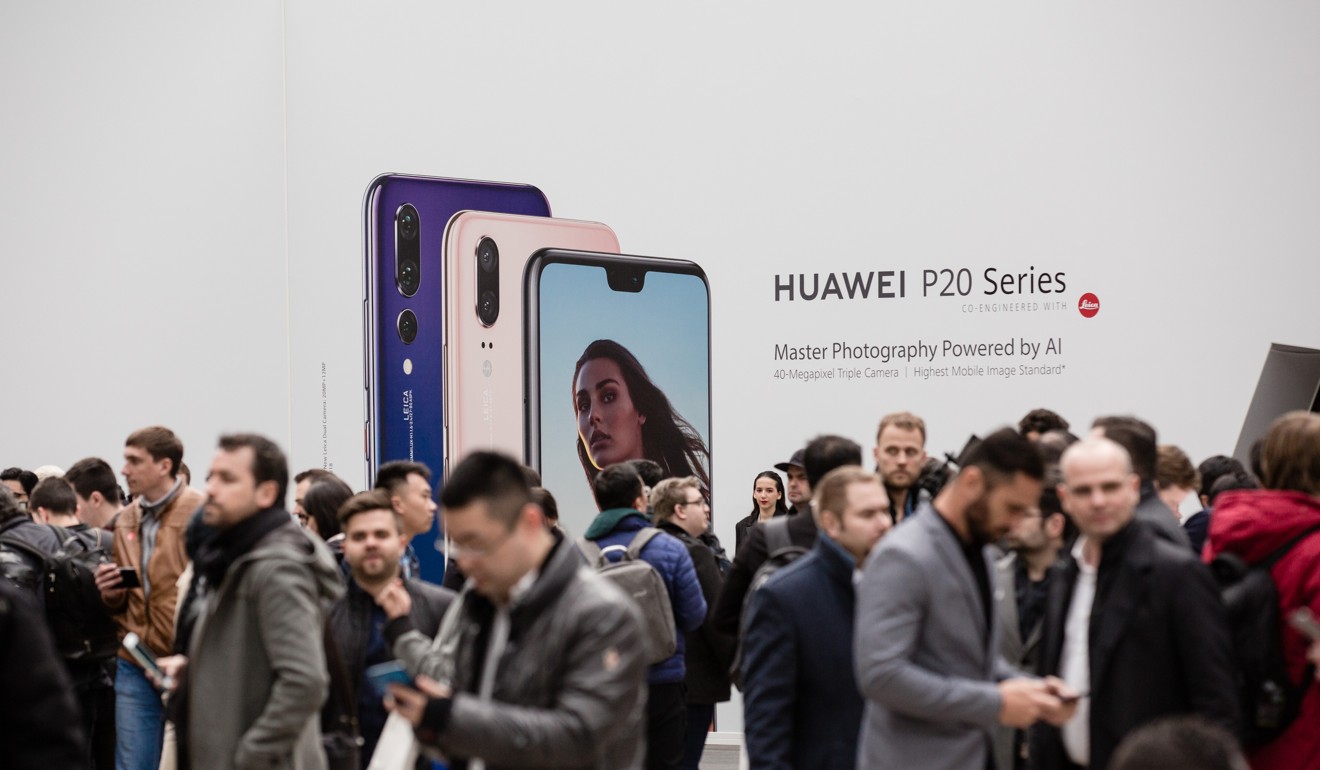 Attendees stand in front of a Huawei Technologies sign during the company’s P20 Pro smartphone unveiling event in Paris, France, on March 27. Huawei is a Chinese brand that has made inroads into the European market. Photo: Bloomberg